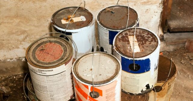 Pile of old rusted paint cans that need to be disposed.