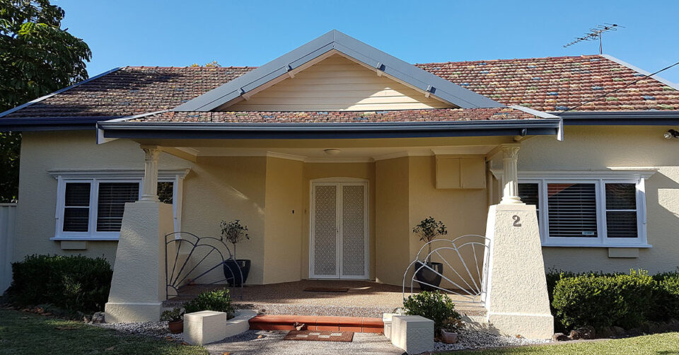 Front of home in Sydney, freshly painted in cream with blue trim by Advanced Painting Pty Ltd.